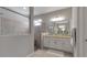 Modern bathroom featuring walk-in shower, granite counters, and ample cabinet space at 15607 White Linen Dr, Bradenton, FL 34211
