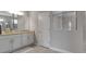 Contemporary bathroom boasts granite countertops, a glass-enclosed shower, and modern fixtures at 15607 White Linen Dr, Bradenton, FL 34211