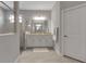 Elegant bathroom showcasing walk-in shower with glass doors and granite countertops at 15607 White Linen Dr, Bradenton, FL 34211