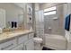 This bathroom features a shower/tub combo, granite countertops and sink at 15607 White Linen Dr, Bradenton, FL 34211