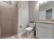 This bathroom features a shower, toilet, sink, and granite countertops at 15607 White Linen Dr, Bradenton, FL 34211