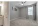 This bedroom features gray walls, neutral carpet and a large window at 15607 White Linen Dr, Bradenton, FL 34211