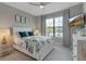 This bedroom features a queen-size bed, ceiling fan, and a large window at 15607 White Linen Dr, Bradenton, FL 34211