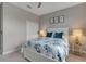 This bedroom has a ceiling fan, queen-size bed and white closet doors at 15607 White Linen Dr, Bradenton, FL 34211
