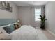 Cozy bedroom featuring soft bedding, a serene color palette, and a bright window at 15607 White Linen Dr, Bradenton, FL 34211