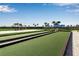Bocce ball court with a vibrant blue canopy, offering a perfect spot for outdoor entertainment at 15607 White Linen Dr, Bradenton, FL 34211