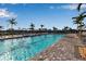 Large community pool lined with lounge chairs offering relaxation and recreation under the sun at 15607 White Linen Dr, Bradenton, FL 34211