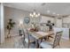 Bright dining room features modern chandelier, decorative rug and seamlessly connects to the kitchen at 15607 White Linen Dr, Bradenton, FL 34211