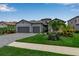 Beautifully landscaped single-Gathering home with a three-car garage and manicured front yard at 15607 White Linen Dr, Bradenton, FL 34211