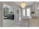 Bright foyer featuring tile floors, a modern chandelier, and an open view into the living spaces at 15607 White Linen Dr, Bradenton, FL 34211