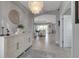 Elegant foyer featuring tile floors, a modern chandelier, and an open view into the living spaces at 15607 White Linen Dr, Bradenton, FL 34211