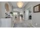 Elegant foyer featuring tile floors, a modern chandelier, and an open view into the living spaces at 15607 White Linen Dr, Bradenton, FL 34211