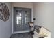 Charming front doors with glass panes and a decorative handle, complemented by a bench and floral accents at 15607 White Linen Dr, Bradenton, FL 34211