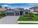 Charming single-story home with a three-car garage, paver driveway and walkway, and well-maintained landscaping at 15607 White Linen Dr, Bradenton, FL 34211