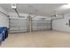 Spacious three-car garage with ample storage and overhead lighting, perfect for vehicles and projects at 15607 White Linen Dr, Bradenton, FL 34211