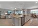 Kitchen island featuring stainless steel dishwasher and sink, that connects to the living room at 15607 White Linen Dr, Bradenton, FL 34211