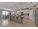 Open kitchen featuring a large island with pendant lighting and barstools, flowing into the dining area at 15607 White Linen Dr, Bradenton, FL 34211