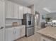 Bright kitchen boasting granite countertops, white cabinetry and stainless steel refrigerator at 15607 White Linen Dr, Bradenton, FL 34211