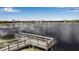Scenic lake view with a wooden pier offering a serene waterfront experience in the community at 15607 White Linen Dr, Bradenton, FL 34211
