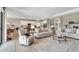 Open living area showcasing comfortable seating, tile floors, and seamless flow to the modern kitchen at 15607 White Linen Dr, Bradenton, FL 34211