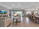 Open floorplan living room flows into dining area, featuring tile floors, modern furniture and outdoor views at 15607 White Linen Dr, Bradenton, FL 34211