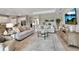 Spacious living area with tile floors, comfortable seating, and an open layout to the kitchen at 15607 White Linen Dr, Bradenton, FL 34211