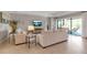 Bright living room with tile floors, comfortable seating, and large sliding glass doors to outdoor area at 15607 White Linen Dr, Bradenton, FL 34211