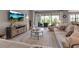 Spacious living area with tile floors, comfortable seating, neutral décor, and a view of the outdoor area at 15607 White Linen Dr, Bradenton, FL 34211