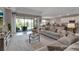 Open living area showcasing comfortable seating, tile floors, and seamless flow to the kitchen and patio at 15607 White Linen Dr, Bradenton, FL 34211