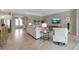 Open living area featuring tile floors, comfortable seating, a TV, and an elegant entryway at 15607 White Linen Dr, Bradenton, FL 34211
