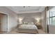 Bright main bedroom with tray ceiling, a serene color scheme, and ample space at 15607 White Linen Dr, Bradenton, FL 34211