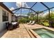 Outdoor dining and lounging by the screened-in pool with spa create a perfect setting for relaxation and entertaining at 15607 White Linen Dr, Bradenton, FL 34211
