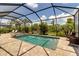 Private screened-in pool and spa with manicured landscaping at 15607 White Linen Dr, Bradenton, FL 34211