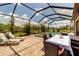 A gorgeous screened pool area with comfortable lounge chairs and outdoor dining for elegant entertaining at 15607 White Linen Dr, Bradenton, FL 34211