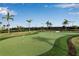 Putting green for refining golf skills with well-manicured lawn and flag markers at 15607 White Linen Dr, Bradenton, FL 34211