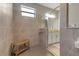 Spacious walk-in shower with bench and window, featuring modern fixtures and ample natural light at 15607 White Linen Dr, Bradenton, FL 34211