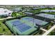 Aerial view of tennis courts next to community lakes and amenities at 15607 White Linen Dr, Bradenton, FL 34211