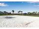 Beach volleyball court with white sand and nearby landscaping provides outdoor activity and recreation at 15607 White Linen Dr, Bradenton, FL 34211