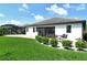Back of house with screened in patio, lush landscaping and a fenced in yard at 1919 Woodleaf Hammock Ct, Bradenton, FL 34211