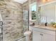 Modern bathroom with a glass-enclosed shower, stone floor, and a white vanity with a quartz countertop at 1919 Woodleaf Hammock Ct, Bradenton, FL 34211