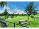 The community dog park provides a secure, fenced area for dogs to play with picnic tables for their owners at 1919 Woodleaf Hammock Ct, Bradenton, FL 34211