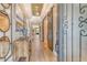 Elegant hallway featuring wood floors, stylish decor, and a unique ceiling design at 1919 Woodleaf Hammock Ct, Bradenton, FL 34211