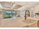 Bright kitchen with a large island and views to the outdoor patio at 1919 Woodleaf Hammock Ct, Bradenton, FL 34211