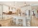 Modern kitchen with white cabinetry, stainless steel appliances, and a central island with seating at 1919 Woodleaf Hammock Ct, Bradenton, FL 34211