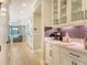 Beautiful kitchen area with white cabinets, glass display case, and stainless steel appliances at 1919 Woodleaf Hammock Ct, Bradenton, FL 34211
