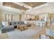 Spacious living room with a large sectional sofa flowing into the kitchen and hallway at 1919 Woodleaf Hammock Ct, Bradenton, FL 34211