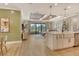 Open-concept living space with modern kitchen, wood floors, and lots of natural light at 1919 Woodleaf Hammock Ct, Bradenton, FL 34211