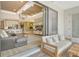 Open-concept living room with modern furnishings and sliding glass doors to an outdoor patio at 1919 Woodleaf Hammock Ct, Bradenton, FL 34211