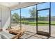 Covered patio with a wood table and view of the backyard at 1919 Woodleaf Hammock Ct, Bradenton, FL 34211