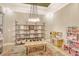 Charming playroom with stylish shelving, a play kitchen, and a whimsical dollhouse for endless imaginative adventures at 1919 Woodleaf Hammock Ct, Bradenton, FL 34211